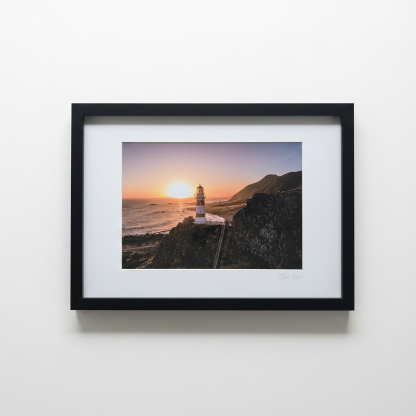 Lighthouse sunset frame on white